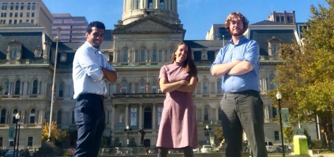 Members of City Performance Mangement Team stand in front of City Hall
